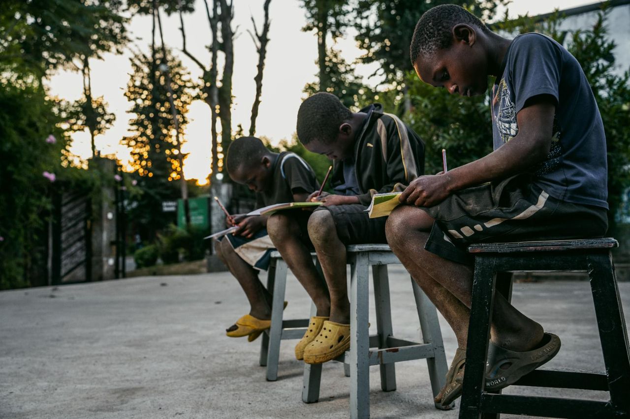 Children from our Talent Programme drawing together as the sun sets.